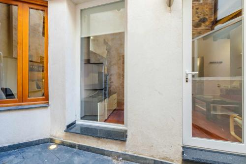 une porte en verre d'un bâtiment avec une fenêtre dans l'établissement Apartamento con patio junto a la Catedral by Toledo AP, à Tolède