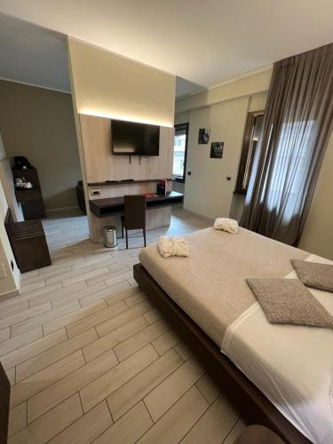 a bedroom with a bed and a desk and a television at Hotel Diplomatic in Turin