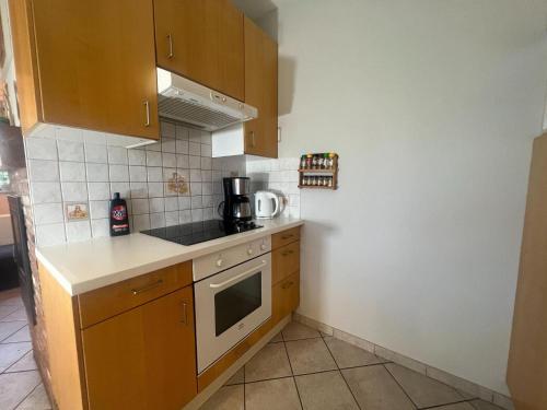 a small kitchen with a stove and a microwave at Relaxing Villa with Pool in Filot