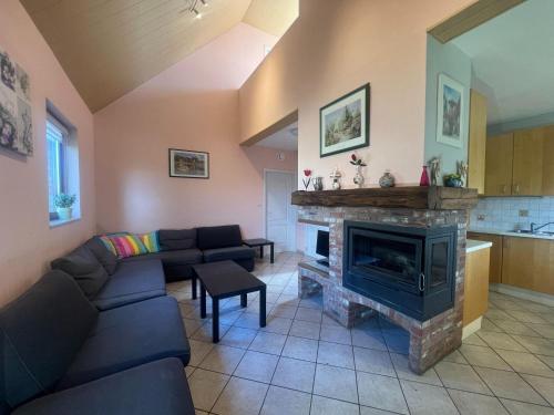a living room with a couch and a fireplace at Relaxing Villa with Pool in Filot