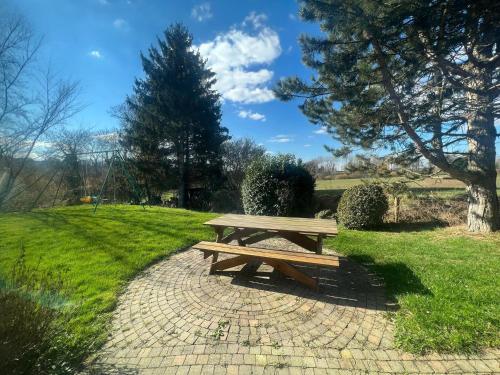 a wooden picnic table sitting on a brick path at Relaxing Villa with Pool in Filot