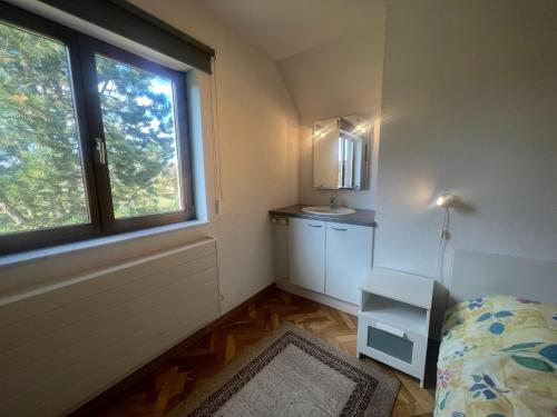 a small bedroom with a bed and a window at Relaxing Villa with Pool in Filot