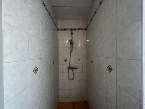a bathroom with a shower with white tiles at Relaxing Villa with Pool in Filot