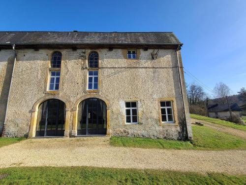 an old stone building on top of a hill at Accommodation in the forges of Orval in Abbaye dʼOrval