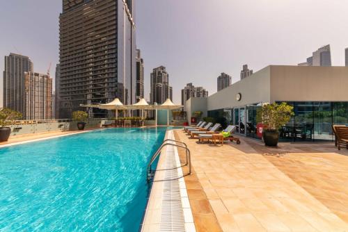 a large swimming pool on the roof of a building at Exquisite Dubai's Urban Living in the City Centre in Dubai