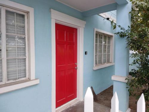 a red door on the side of a blue house at Homestay at 24 Laguna Bel-Air by Red Door House Rental in Santa Rosa