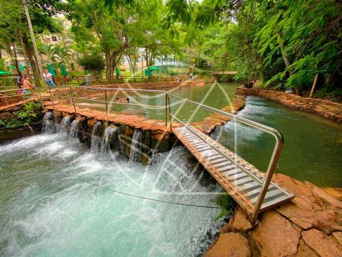 a water fall in a park with a waterfall at Thermas Paradise - 1 Quarto in Rio Quente