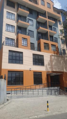 a large apartment building with a lot of windows at lovely modern 1,2 bedroom apartment in town in Nakuru