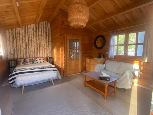 a bedroom with a bed and a couch and a table at Maison Saint Paul in La Colle-sur-Loup