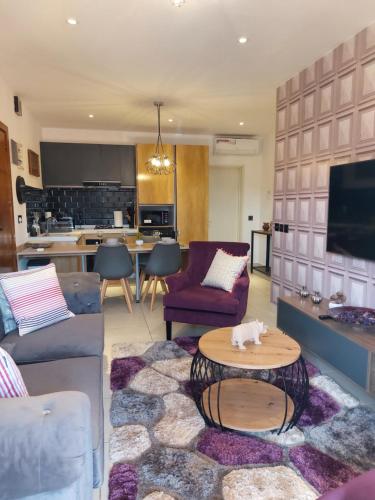 a living room with a couch and a table at Forest View Apartments in Kololi