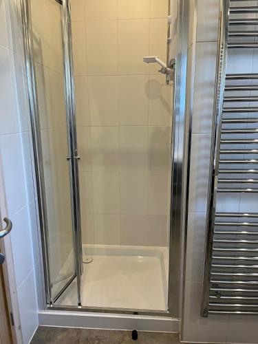 a shower with a glass door in a bathroom at Skyline Lodge Loch Lomond Castle Lodges in Balloch