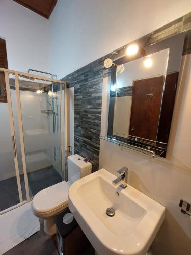 a bathroom with a sink and a toilet and a mirror at Comfy Home near the town in Maharagama