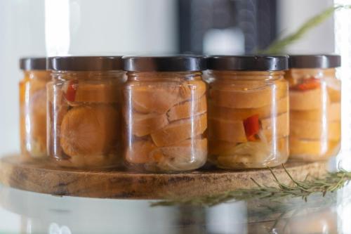 a group of jars of pickles on a shelf at Hotel Krokus in Pec pod Sněžkou