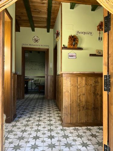 an entrance to a building with aoyer with a table at Casa Rural Juan de Austria in Cuacos de Yuste