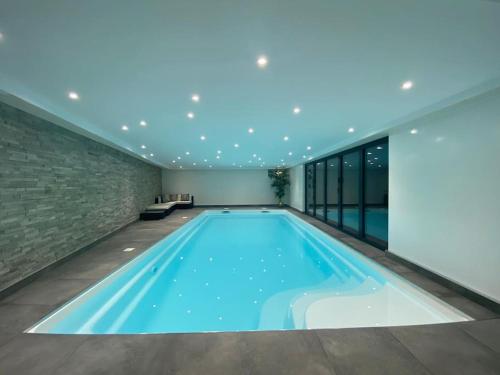 a swimming pool in a house with a ceiling at A luxury unique home spa - White Stones Retreats. in Weymouth