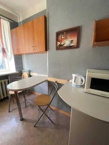 a small kitchen with a table and a microwave at Apartments on Moskovskaja in Dnipro
