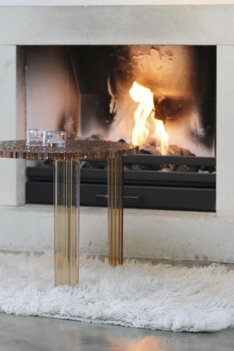 a table in front of a fireplace with flames at Droste's Herberg in Tubbergen