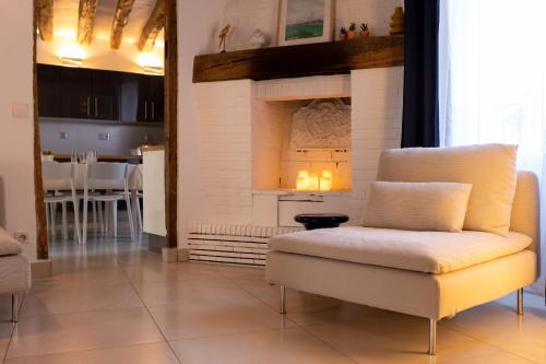 a living room with a chair and a fireplace at La Maison Coco à 8min de Disneyland Paris in Montévrain