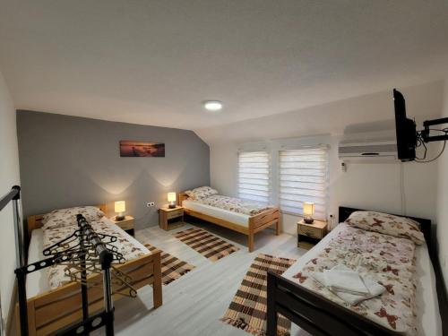 Postel nebo postele na pokoji v ubytování Apartments Daris