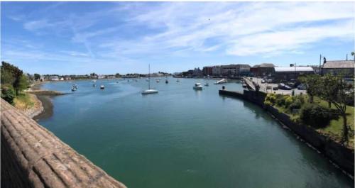 a river with many boats in the water at Kitty’s Keep in Dungarvan