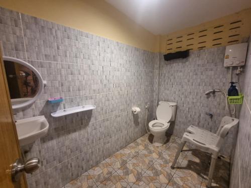 a bathroom with a toilet and a sink at Ban Tai - Nice house in a quiet area 2 min from main road in Thongsala