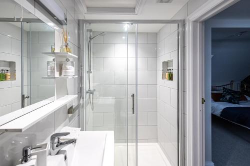 a bathroom with a shower and a sink at Channel View Guest House in Weymouth