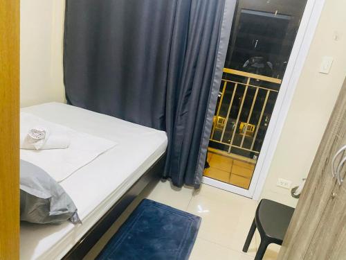 a small room with a bed and a window at SHELL RESIDENCE C9 NEAR AIRPORT & MALL OF ASIA in Manila