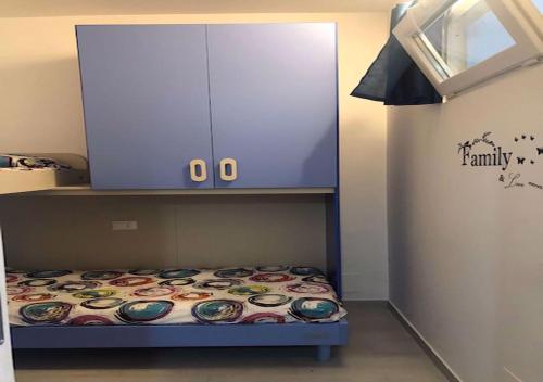 a small bed with a cabinet on top of it at Sol Apartament, fronte spiaggia in Silvi Marina