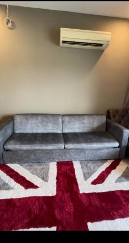 a couch sitting in a living room with a rug at Lux 3BR max 16pax Suite Puteri Habour sea view near Legoland in Nusajaya