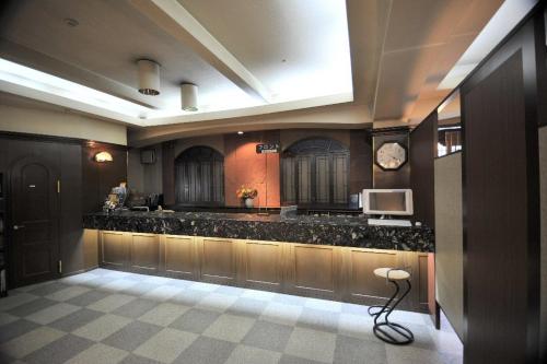 a large room with a kitchen with black counter tops at Hotel Saint Paul Nagasaki in Nagasaki