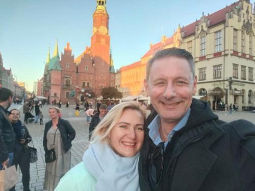 a man and woman posing for a picture in a city at Cozy room - 10 min.from Rynek in Wrocław