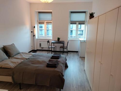 a bedroom with a bed and a table and chairs at Cozy room - 10 min.from Rynek in Wrocław