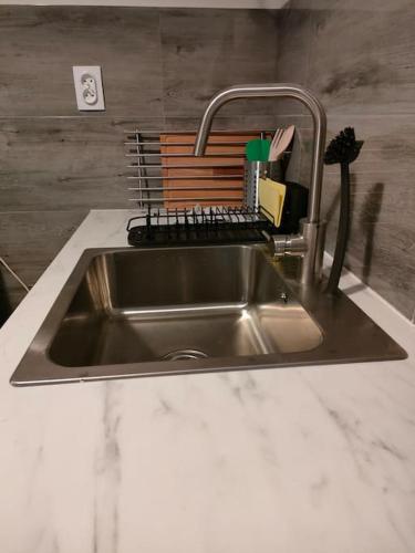 a stainless steel kitchen sink with a faucet at Cozy room - 10 min.from Rynek in Wrocław