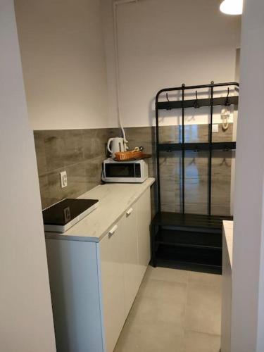 a small kitchen with a sink and a microwave at Cozy room - 10 min.from Rynek in Wrocław