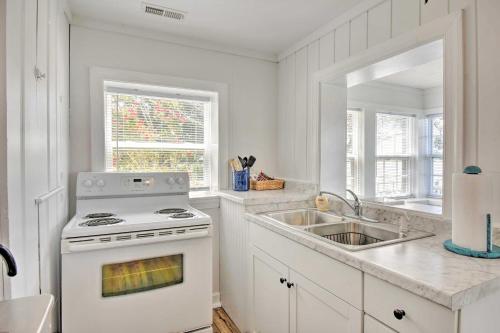 a white kitchen with a stove and a sink at Romantic Waterfront Abode with Patio and Dock! in Deltaville