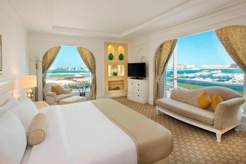 a bedroom with a large bed and a large window at Habtoor Grand Resort, Autograph Collection in Dubai