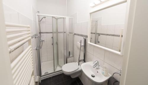 a white bathroom with a toilet and a sink at LokoMotel-Wohnung, Luxus Ferienwohnung im Lokschuppen in Stadtlohn