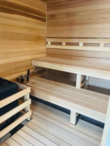 a sauna with wooden walls and benches in a room at Sugar Mountain Mile High Cozy Condo! in Sugar Mountain