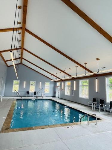 a large swimming pool in a building with chairs at Sugar Mountain Mile High Cozy Condo! in Sugar Mountain