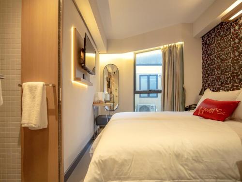 a hotel room with a bed and a window at Belive&More in Macau