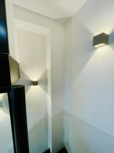 a room with two lights on a wall at Residence Louis Quartier Casino in Vittel
