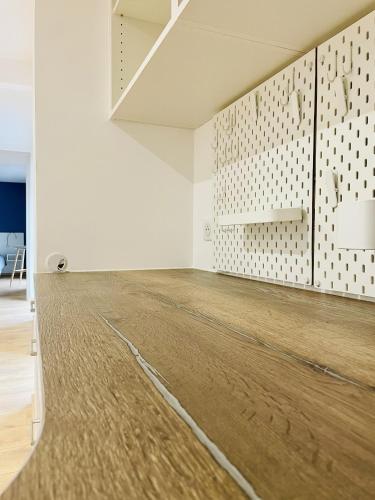 an empty room with a wooden floor and white walls at Residence Louis Quartier Casino in Vittel