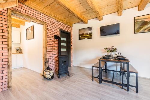 a living room with a table and a wood stove at Antkowe Wzgórze in Polańczyk