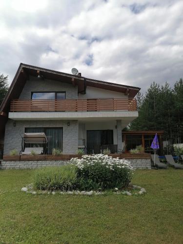 a house with a deck on the side of it at Къща за гости Радост Guest House Radost in Razlog