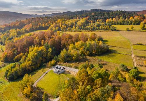 an aerial view of a house in the middle of a field at Antkowe Wzgórze in Polańczyk