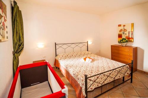a bedroom with a bed and a dresser in it at residence lu soli budoni affitti in Budoni