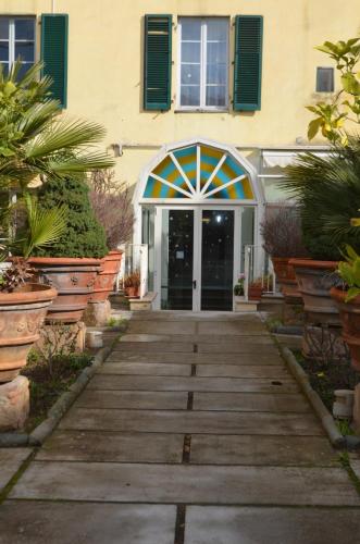 a house with a wooden walkway leading to a door at Casa per ferie religiosa Figlie di Nazareth in Pisa