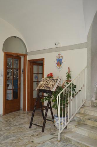 a table in a room with a staircase and a door at Casa per ferie religiosa Figlie di Nazareth in Pisa