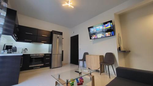 a living room with a kitchen with a table and chairs at Konnet Apartment in Rhodes Town