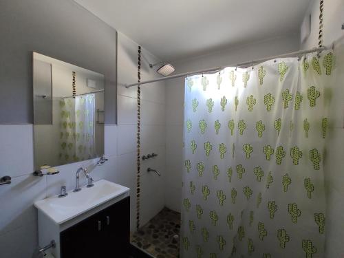 a bathroom with a sink and a shower curtain at Las margaritas in Uspallata